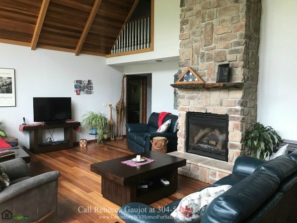 Renick WV Country Properties for Sale - Even inside this Renick country home’s living room, nature will find you and make you appreciate its grandeur through its large windows.
