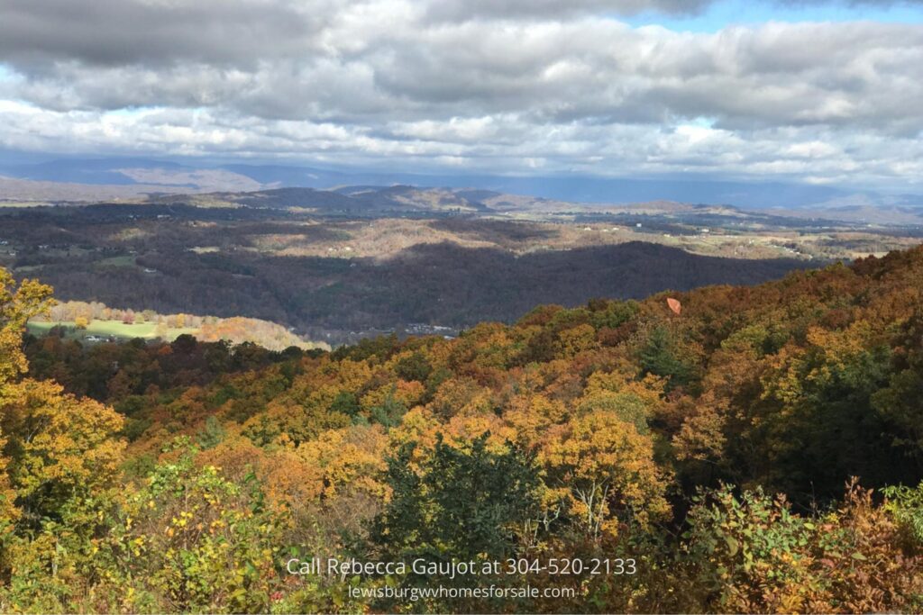 Stunning view of lot for sale atop White Rock Mountain with colorful fall foliage, perfect for adventure seekers